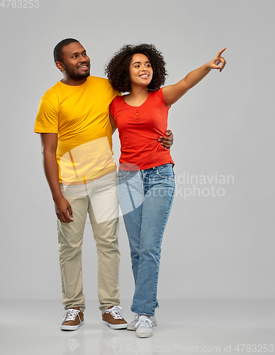 Image of african american couple pointing to something