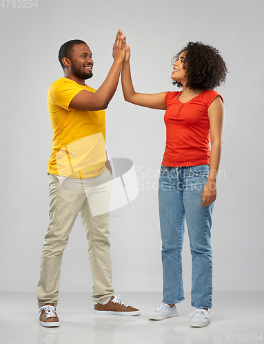 Image of happy african american couple making high five