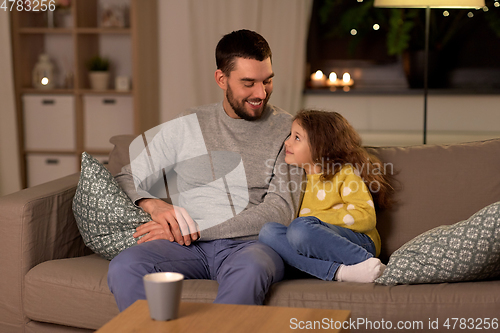 Image of happy father and little daughter at home at night