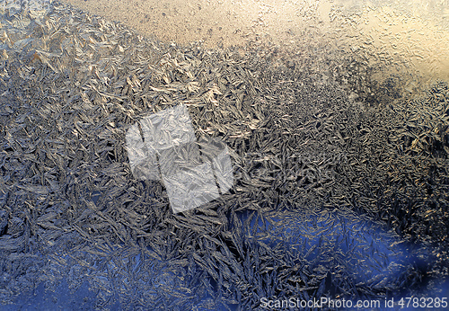 Image of Beautiful ice pattern and sunlight close-up on winter glass