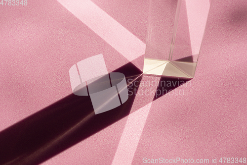 Image of Straight geometric shapes of light and shadow in abstraction on pink