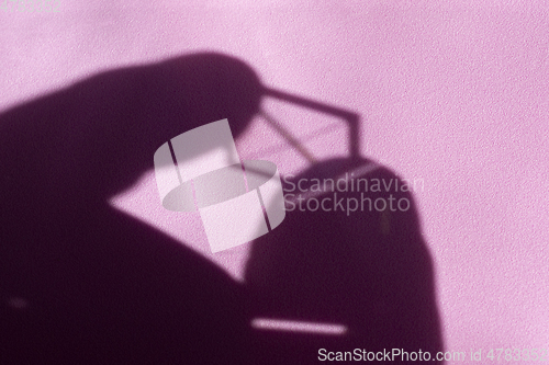 Image of Shapes of shadow and light in an abstract background on pink