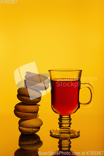 Image of Strong aromatic tea in cup and marshmallows on a bright background