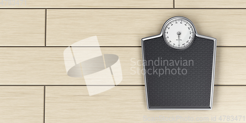 Image of Weighing scale on wood floor