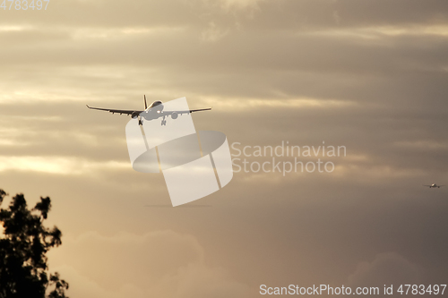 Image of air plane in sunset sky