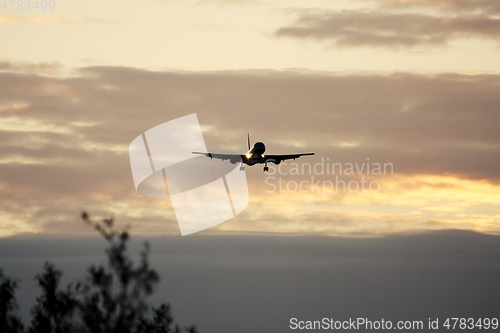 Image of air plane in sunset sky