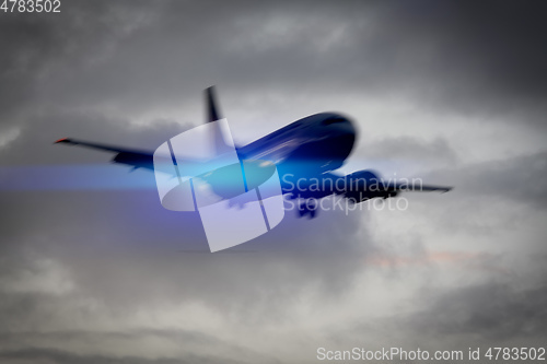 Image of plane in the sky motion blur with blue light flare