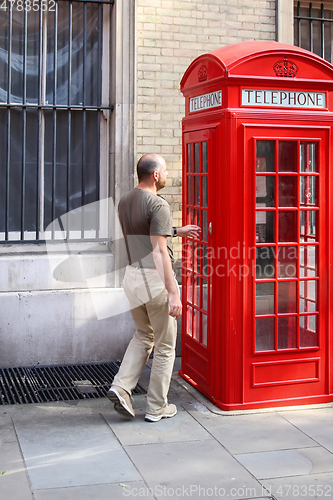 Image of phone box London with man