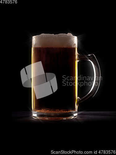 Image of typical beer in a glass with black background