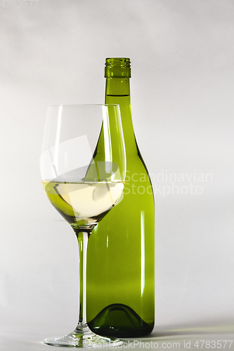 Image of white wine bottle with a glass