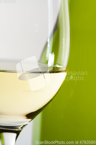 Image of white wine bottle with a glass details