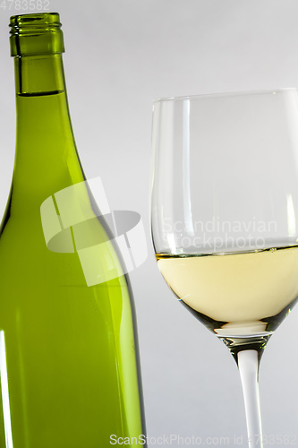 Image of white wine bottle with a glass