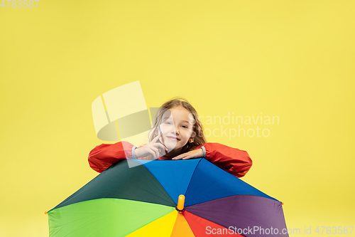 Image of A full length portrait of a bright fashionable girl in a raincoat