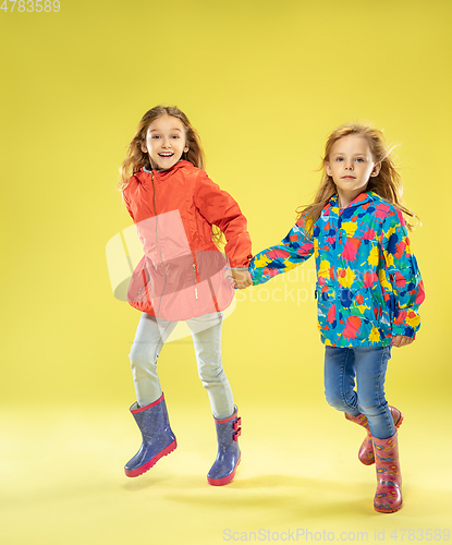 Image of A full length portrait of a bright fashionable girls in a raincoat