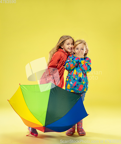 Image of A full length portrait of a bright fashionable girls in a raincoat