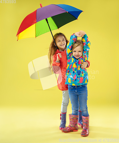 Image of A full length portrait of a bright fashionable girls in a raincoat