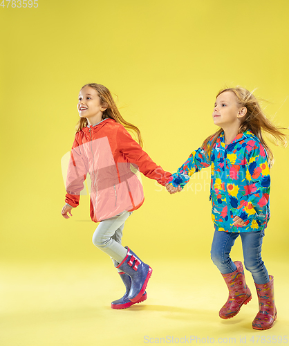 Image of A full length portrait of a bright fashionable girls in a raincoat