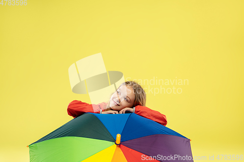 Image of A full length portrait of a bright fashionable girl in a raincoat