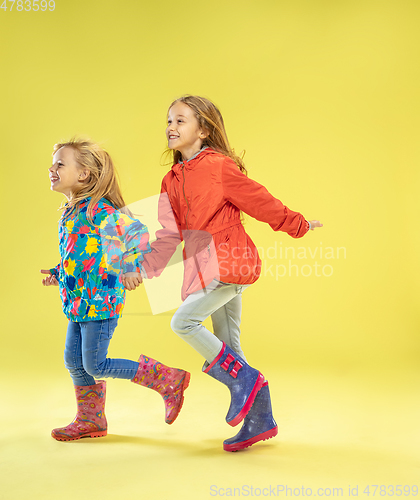 Image of A full length portrait of a bright fashionable girls in a raincoat