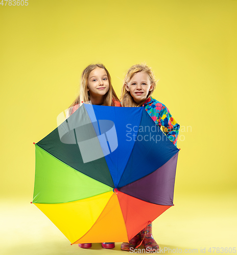 Image of A full length portrait of a bright fashionable girls in a raincoat