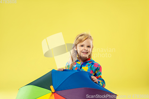 Image of A full length portrait of a bright fashionable girl in a raincoat