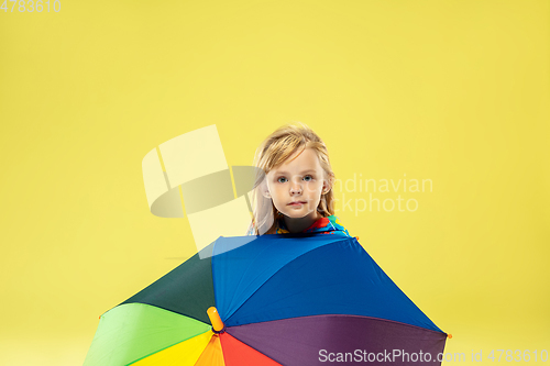 Image of A full length portrait of a bright fashionable girl in a raincoat