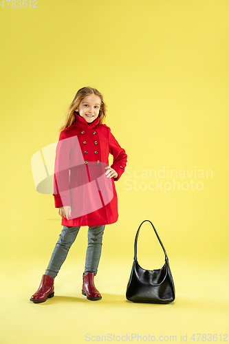 Image of A full length portrait of a bright fashionable girl in a raincoat