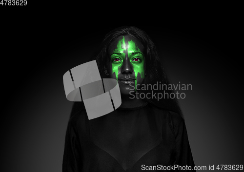 Image of Close up portrait of young woman isolated on black studio background