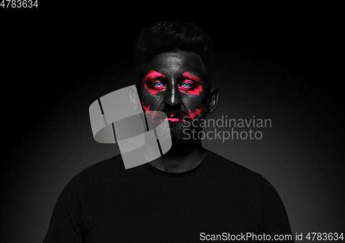 Image of Close up portrait of young man isolated on black studio background