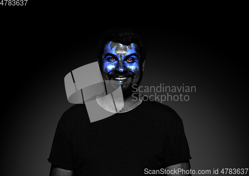 Image of Close up portrait of young man isolated on black studio background