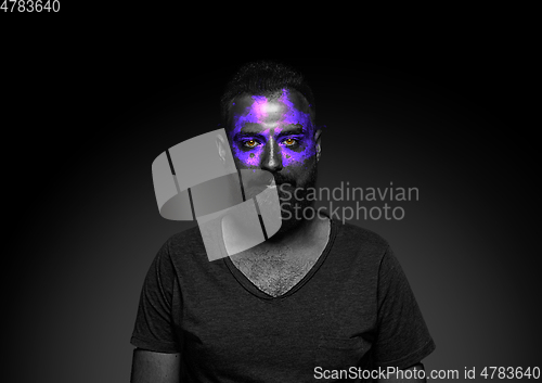 Image of Close up portrait of young man isolated on black studio background