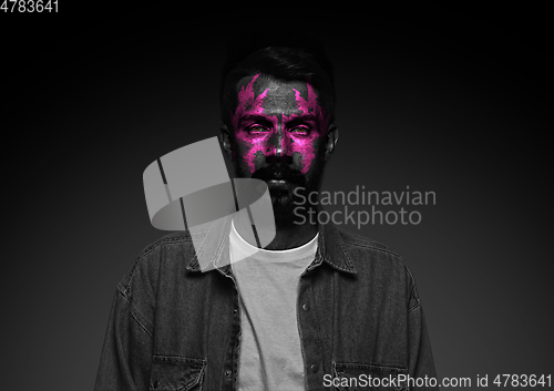 Image of Close up portrait of young man isolated on black studio background