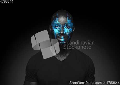 Image of Close up portrait of young man isolated on black studio background