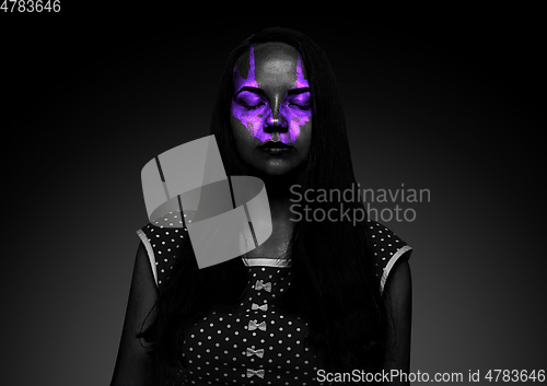 Image of Close up portrait of young woman isolated on black studio background