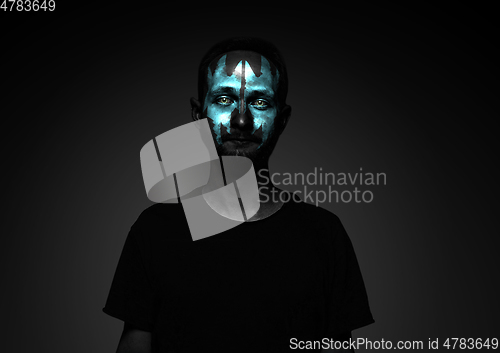 Image of Close up portrait of young man isolated on black studio background