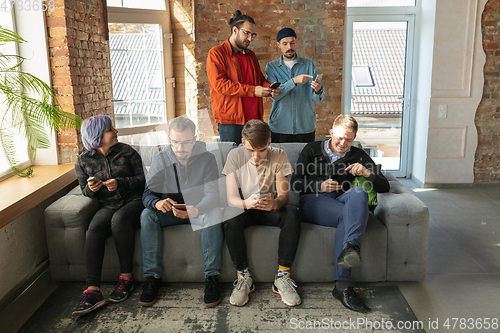 Image of Group of happy young people sharing in social media