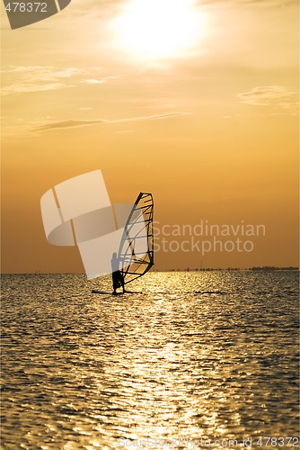 Image of Silhouette of a windsurfer on a sunset