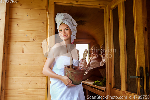 Image of three girls relaxing in sauna