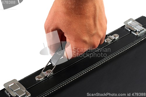 Image of Hand with a black suitcase. Isolated on white background