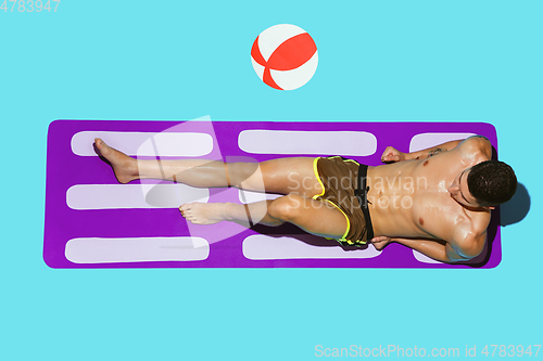 Image of Top view of young caucasian male model\'s resting on beach resort