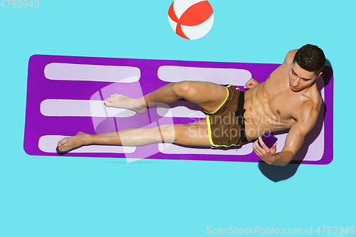 Image of Top view of young caucasian male model\'s resting on beach resort