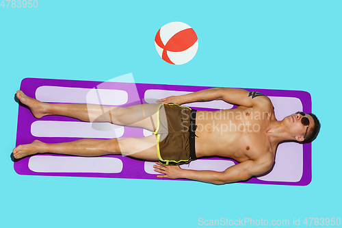 Image of Top view of young caucasian male model\'s resting on beach resort
