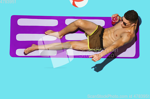 Image of Top view of young caucasian male model\'s resting on beach resort