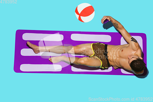 Image of Top view of young caucasian male model\'s resting on beach resort