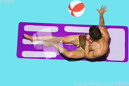 Image of Top view of young caucasian male model\'s resting on beach resort