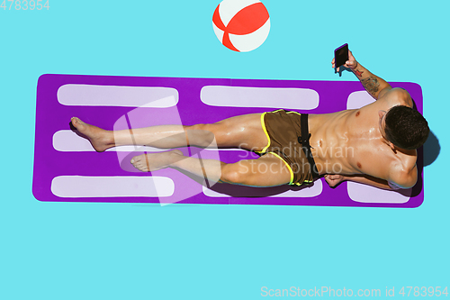Image of Top view of young caucasian male model\'s resting on beach resort