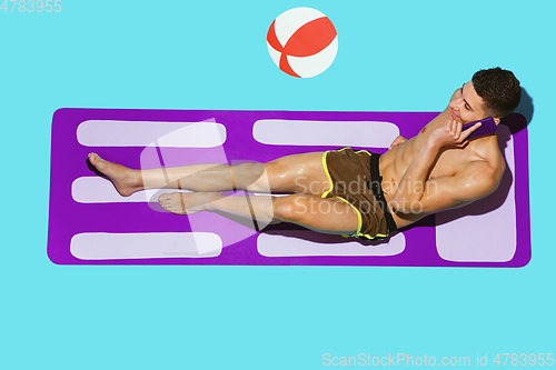 Image of Top view of young caucasian male model\'s resting on beach resort