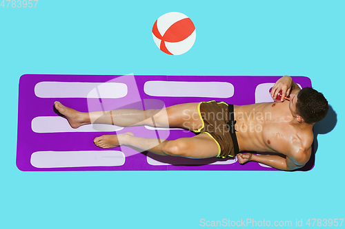 Image of Top view of young caucasian male model\'s resting on beach resort