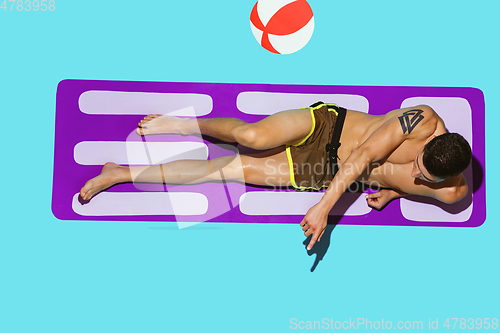 Image of Top view of young caucasian male model\'s resting on beach resort