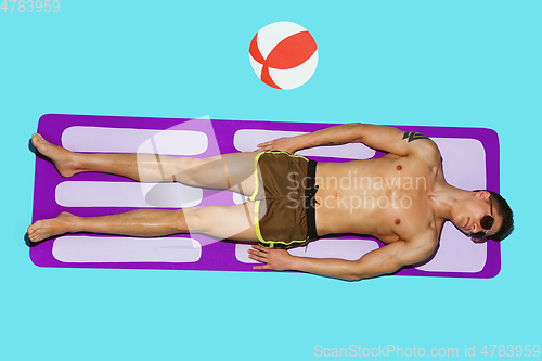 Image of Top view of young caucasian male model\'s resting on beach resort